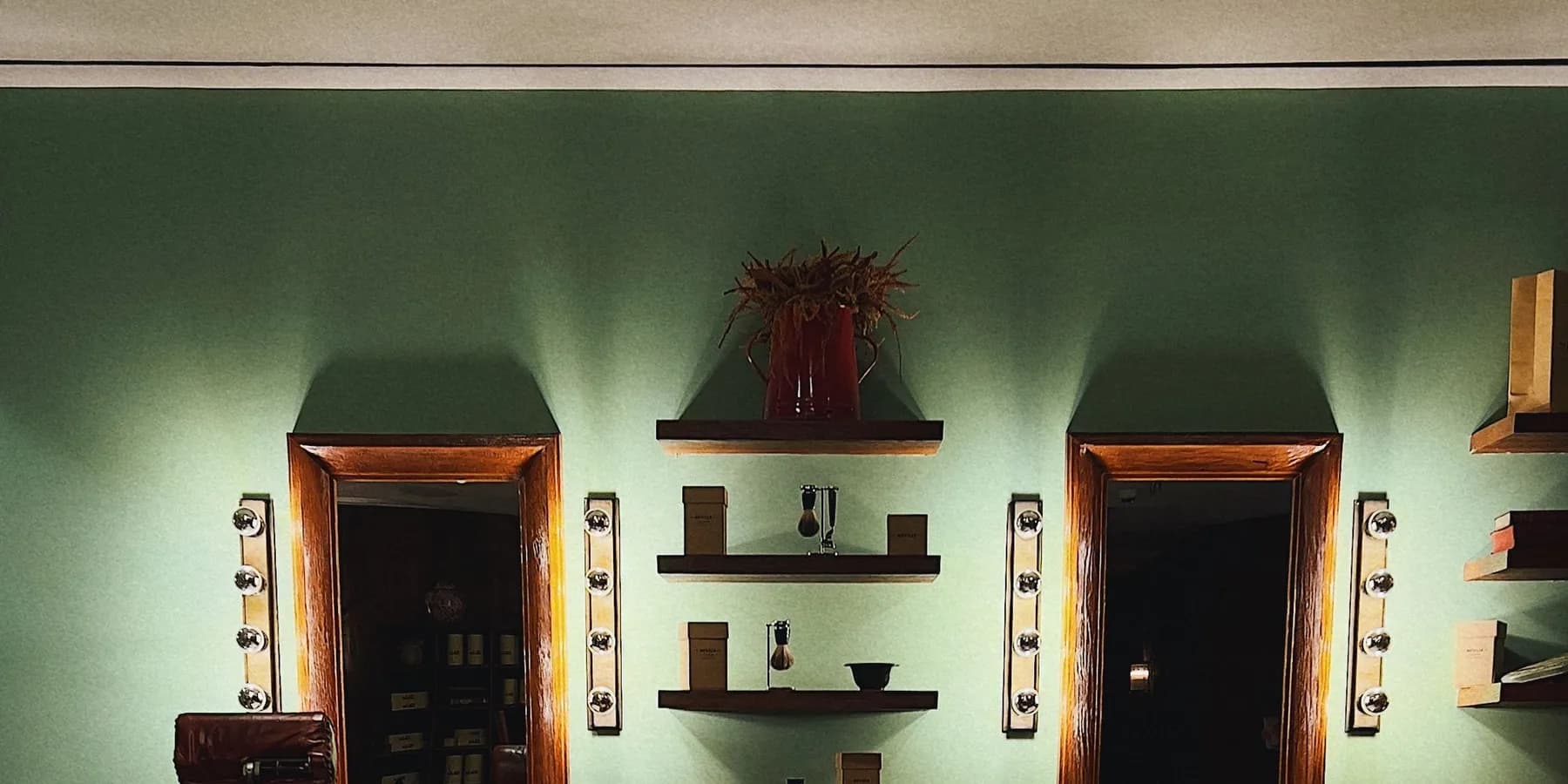 Lavish, dimly lit barbershop interior with premium wood-panel styling stations