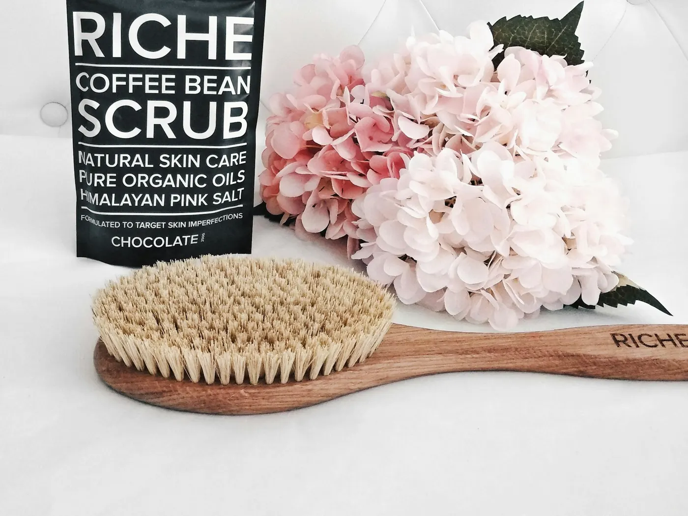Coffee bean body scrub and exfoliating brush used for a body scrub treatment
