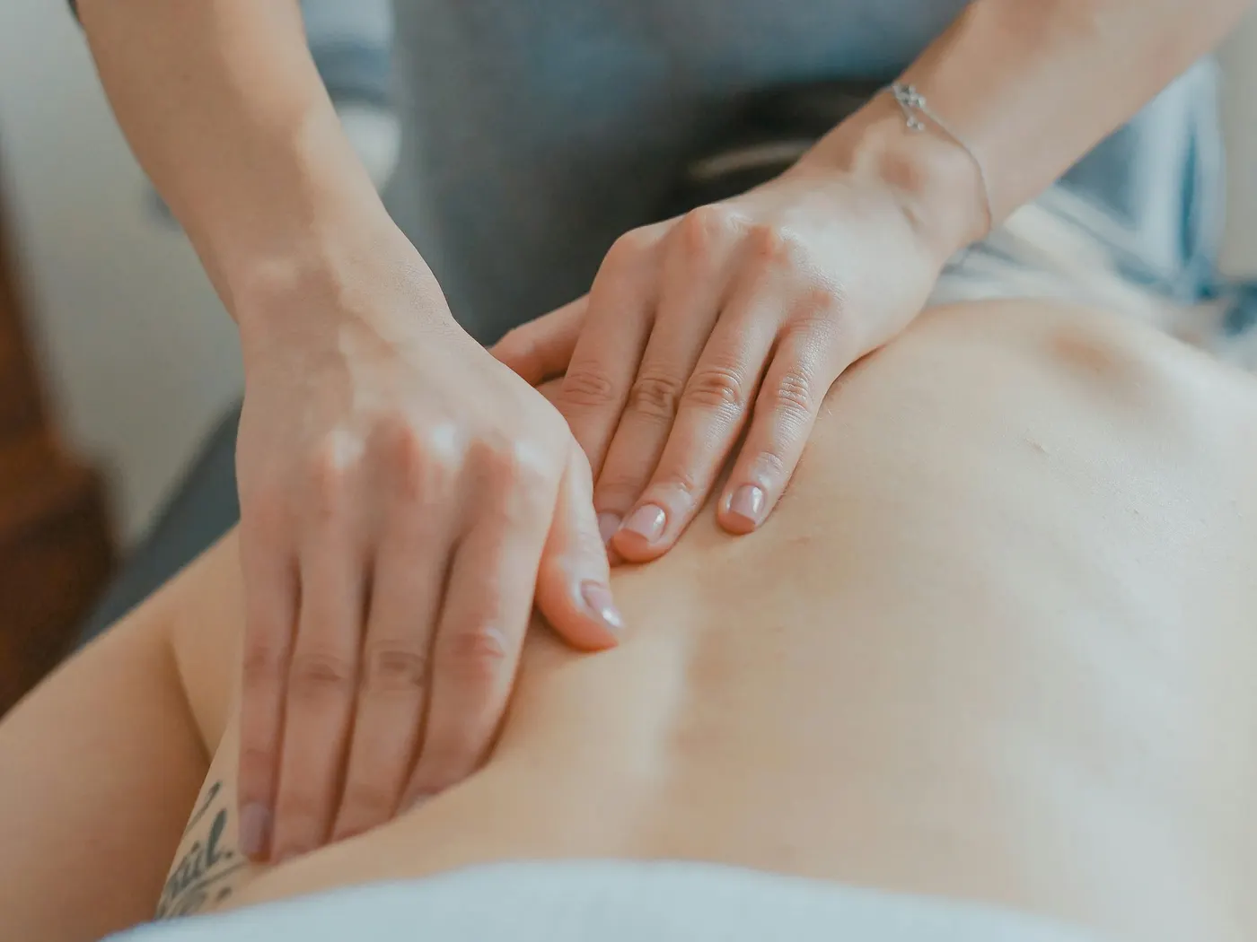 Male therapist massaging a client's back