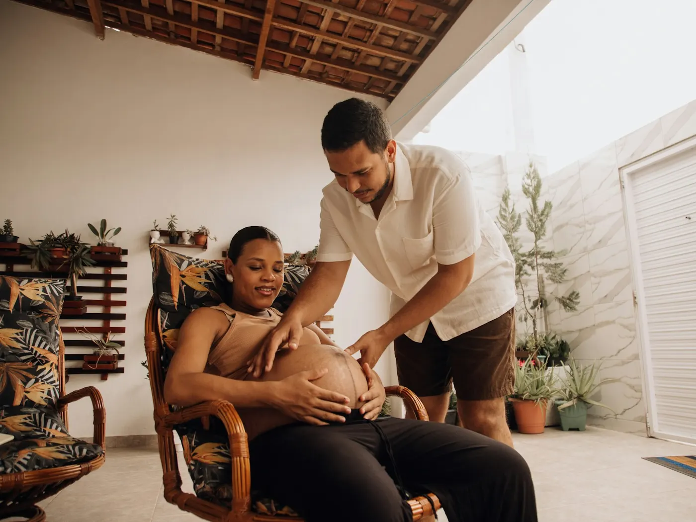 Therapist gently massaging a pregnant client's belly